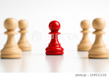 A red figurine separated from two natural figurines symbolizing division or confrontation 129511110