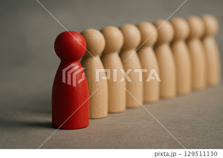 A single red figurine facing forward next to a natural figurine symbolizing partnership, rivalry, or recognition A single red figurine facing forward next to a natural figurine symbolizing partnership, rivalry, or recognition 129511130