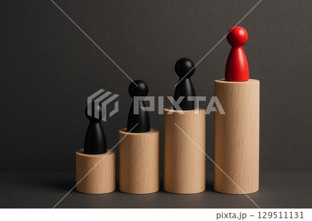 A single red wooden figurine facing a row of natural wood figurines symbolizing leadership, individuality, or confrontation 129511131