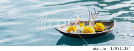 Loy Krathong festival with floating flowers and incense on water, background 129511384
