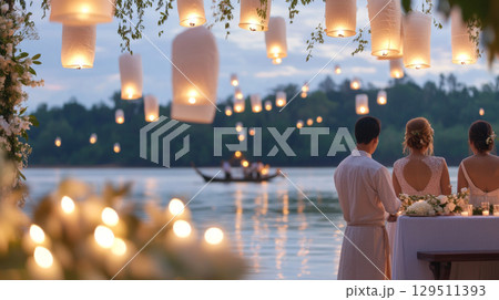 Yi Peng festival showing river lanterns and people at twilight, background 129511393