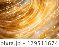 Golden shimmering texture creates a captivating atmosphere filled with light and warmth, resembling liquid gold swirls dancing in the light during a sunlit afternoon 129511674