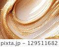 Innovative skin care cream texture showcasing shimmering golden elements in a sleek fluid form, with unique reflections and captivating patterns dancing under soft light 129511682
