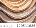 Elegantly flowing golden fabric with shimmering effects illuminated in soft light creates a luxurious atmosphere, showcasing rich textures and a harmonious blend of mocha mousse color of the year 129511686