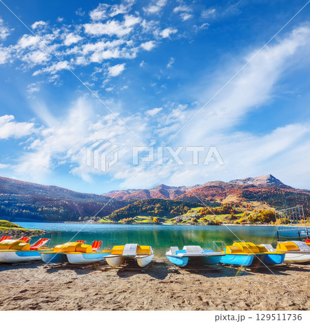 Picturesque autumn view of San Valentino village and Muta or Haidersee lake. Picturesque autumn view of San Valentino village and Muta or Haidersee lake. 129511736