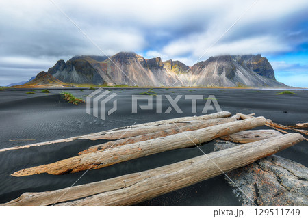 Amazing sunny day and dramatic black sand beach on Stokksnes cape in Iceland 129511749