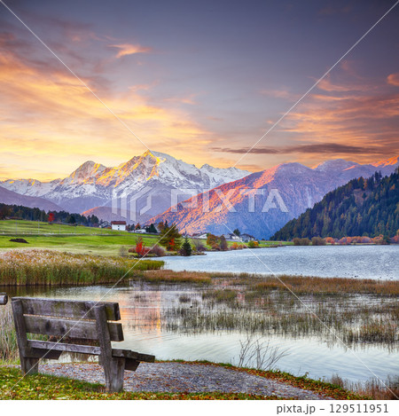 Fabulous autumn view of Haidersee (Lago della Muta) lake with Ortler peak on background. 129511951
