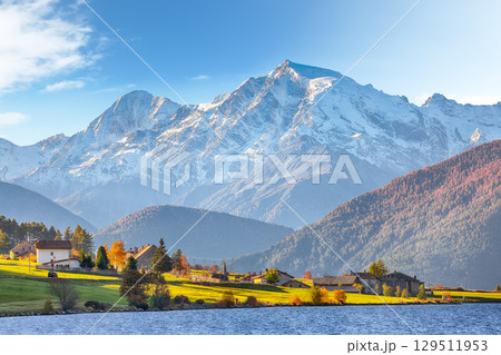Fabulous autumn view of Haidersee (Lago della Muta) lake with Ortler peak on background. Fabulous autumn view of Haidersee (Lago della Muta) lake with Ortler peak on background. 129511953