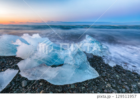 Ramarkable pieces of the iceberg sparkle on famous Diamond Beach at Jokulsarlon lagoon during sunset. Ramarkable pieces of the iceberg sparkle on famous Diamond Beach at Jokulsarlon lagoon during sunset. 129511957