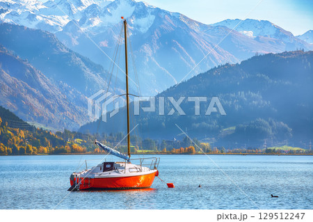 Amazing autumn view of lake and yachts in city Sell Am See. 129512247