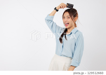 Happy excited asian woman shop showing plastic credit card on head, payment success, money, financial. Beautiful girl showing a credit card, surprised, isolated studio white background Happy excited asian woman shop showing plastic credit card on head, payment success, money, financial. Beautiful girl showing a credit card, surprised, isolated studio white background 129512660