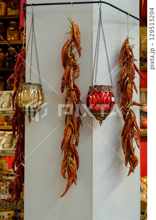 Rustic Market Display: Hanging Dried Red Peppers & Ornate Lanterns 129513204