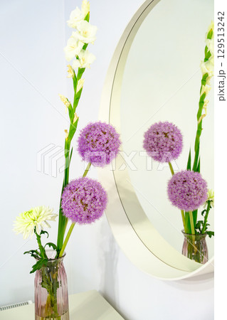 Floral Arrangement and Reflection in Round Mirror Close-up Floral Arrangement and Reflection in Round Mirror Close-up 129513242