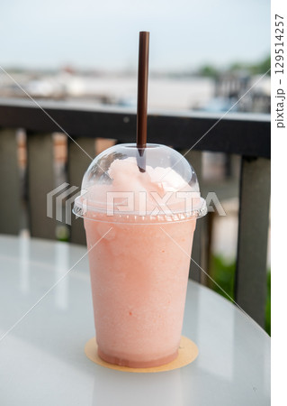A cup of blended lychee on the table, with bokeh background of the river A cup of blended lychee on the table, with bokeh background of the river 129514257