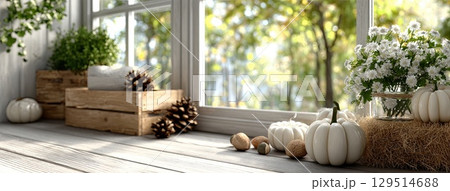 Wooden boxes display pumpkins and pine cones on a window seat providing a warm, inviting atmosphere for fall decoration 129514688