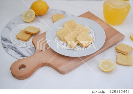 Crispy Lemon Cookies on Wooden Board 129515445