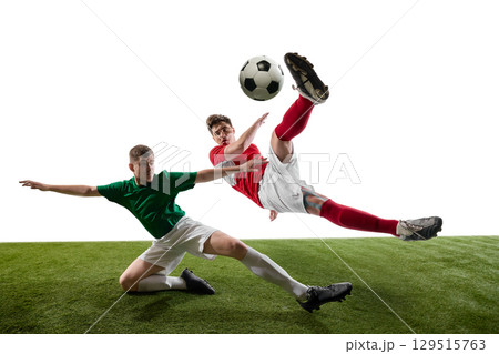 Soccer players in intense mid-air tackle action on green field 129515763