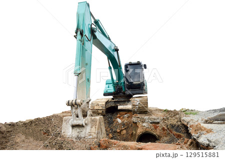 A large excavator is working in a workplace, isolated on a white background. A large excavator is working in a workplace, isolated on a white background. 129515881