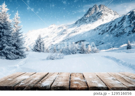 winter blue landscape of alps and brown old table of wood and snow place 129516056