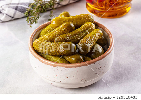 Marinated canned green cornichon cucumbers 129516483