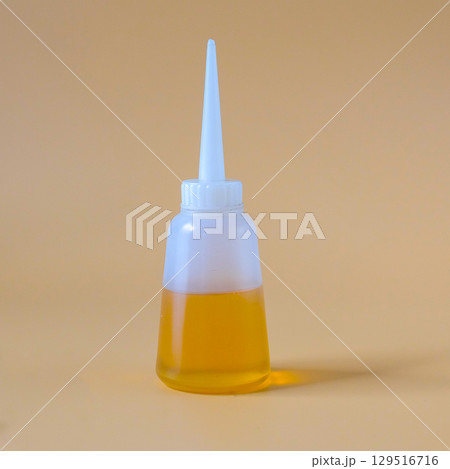 oil lubricant in reuse bottle on color background. oil lubricant in reuse bottle on color background. 129516716
