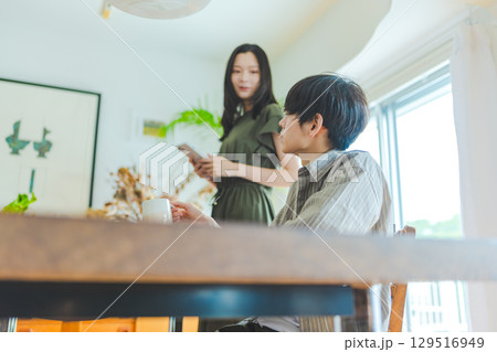 室内で立つ女性と座る男性の会話シーン 室内で立つ女性と座る男性の会話シーン 129516949