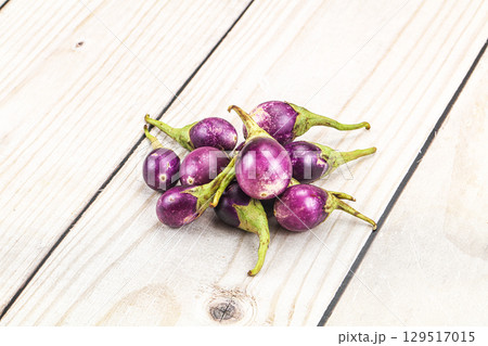 Small organic young purple round eggplant 129517015