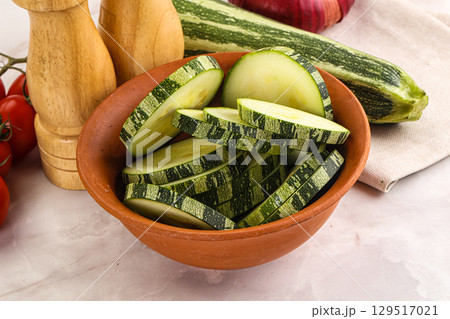 Raw green zucchini slices for cooking 129517021