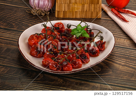 Baked cheeryy momatoes with olive oil Baked cheeryy momatoes with olive oil 129517156