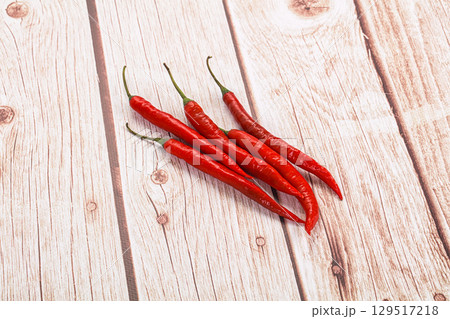 Hot spicy chili pepper heap 129517218