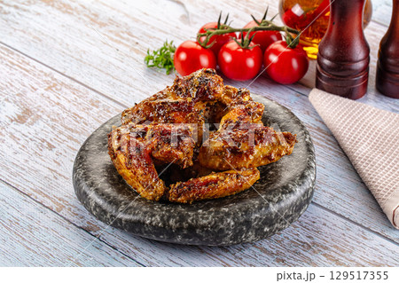 Baked chicken wings with spices 129517355