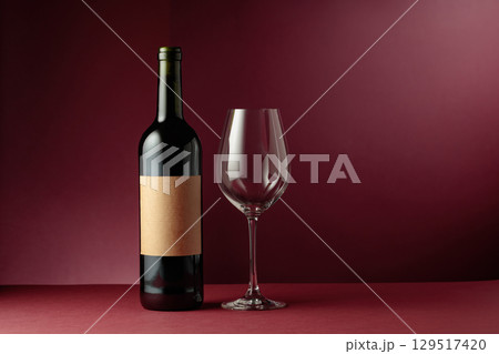Red wine on a dark red background. 129517420