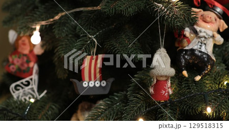 Handcrafted Christmas ornaments on artificial Christmas tree 129518315