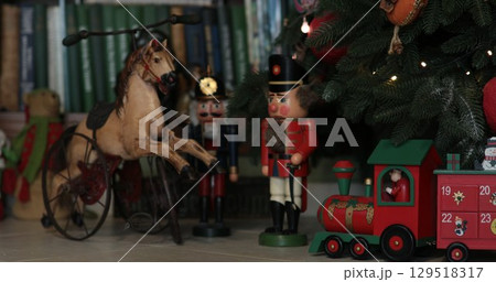 Vintage nutcrackers and advent calendar in shape of train under Christmas tree Vintage nutcrackers and advent calendar in shape of train under Christmas tree 129518317