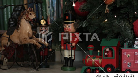 Vintage nutcrackers and advent calendar in shape of train under Christmas tree Vintage nutcrackers and advent calendar in shape of train under Christmas tree 129518318