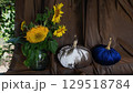 Fall arrangement with sewed stuffed velvet pumpkins and bouquet of sunflowers 129518784
