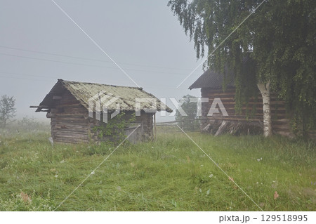 Landscape lonely wooden house in the village in the fog 129518995
