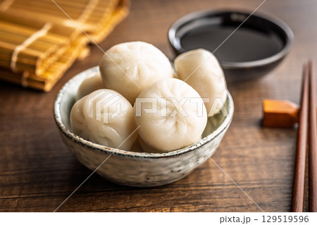 Xiao long bao. Chinese dumplings in bowl on wooden table. 129519596