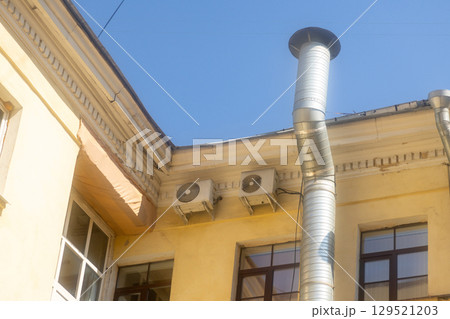 Air conditioners are installed on facade of building. device for comfortable living in hot weather. 129521203