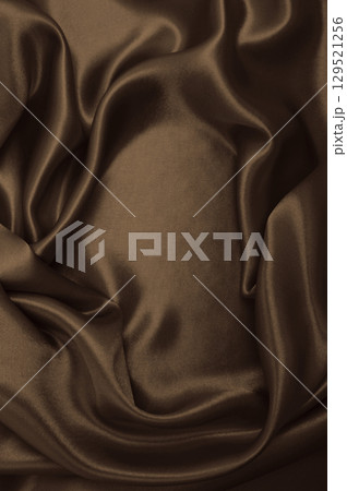 Smooth elegant brown silk or satin luxury cloth texture as abstract background. Luxurious background design wallpaper. In Sepia toned. Retro style Smooth elegant brown silk or satin luxury cloth texture as abstract background. Luxurious background design wallpaper. In Sepia toned. Retro style 129521256