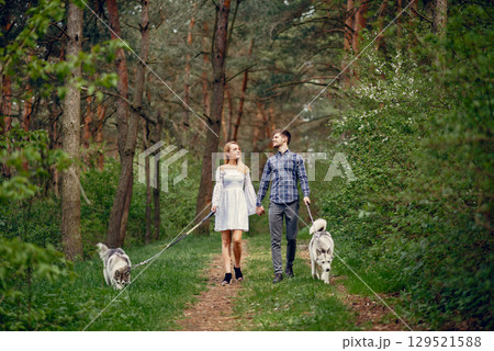 Couple in a forest. Pair with cute dogs. Lady in a white dress 129521588