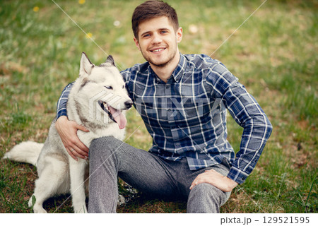 Hundsome man in a park. Guy with cute dog 129521595