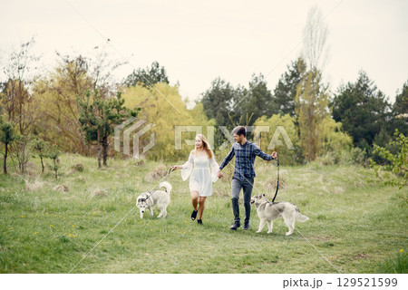 Couple in a forest. Pair with cute dogs. Lady in a white dress 129521599