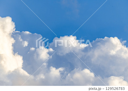 Fluffy White Clouds in Blue Sky 129526783
