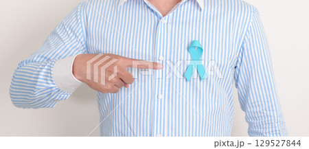 man with blue Ribbon for concept of blue November, November Prostate Cancer Awareness month, World Diabetes day , Men Health month, International men, Father day. Healthcare and world cancer day 129527844