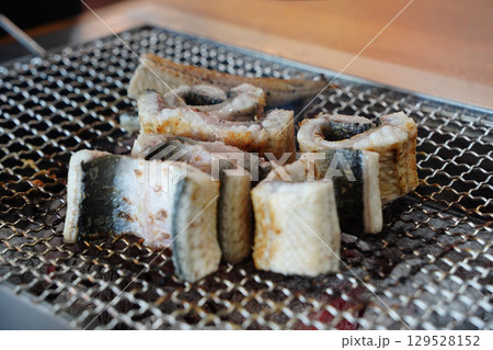 Grilled Eel Slices on Metal Grill 129528152