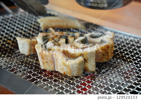 Grilled Eel Slices on Metal Grill 129528153