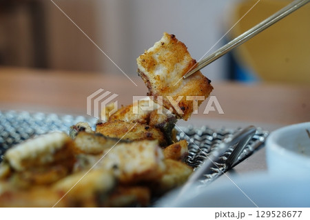 Grilled Eel Pieces in Metal Basket 129528677