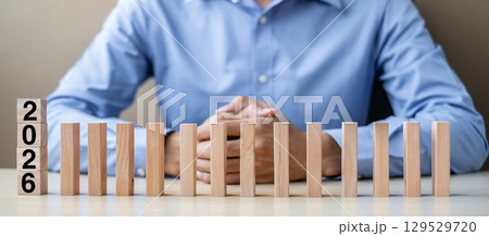 Businessman with  2026 wooden Blocks. Business, Risk Management, Insurance, Resolution, strategy, solution, goal, New Year New You and happy holiday concepts 129529720