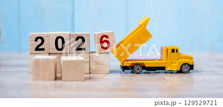 2026 Happy New year with miniature truck or construction vehicle. New Start, Vision, Resolution, goal, industrial, Warehouse concept 2026 Happy New year with miniature truck or construction vehicle. New Start, Vision, Resolution, goal, industrial, Warehouse concept 129529721